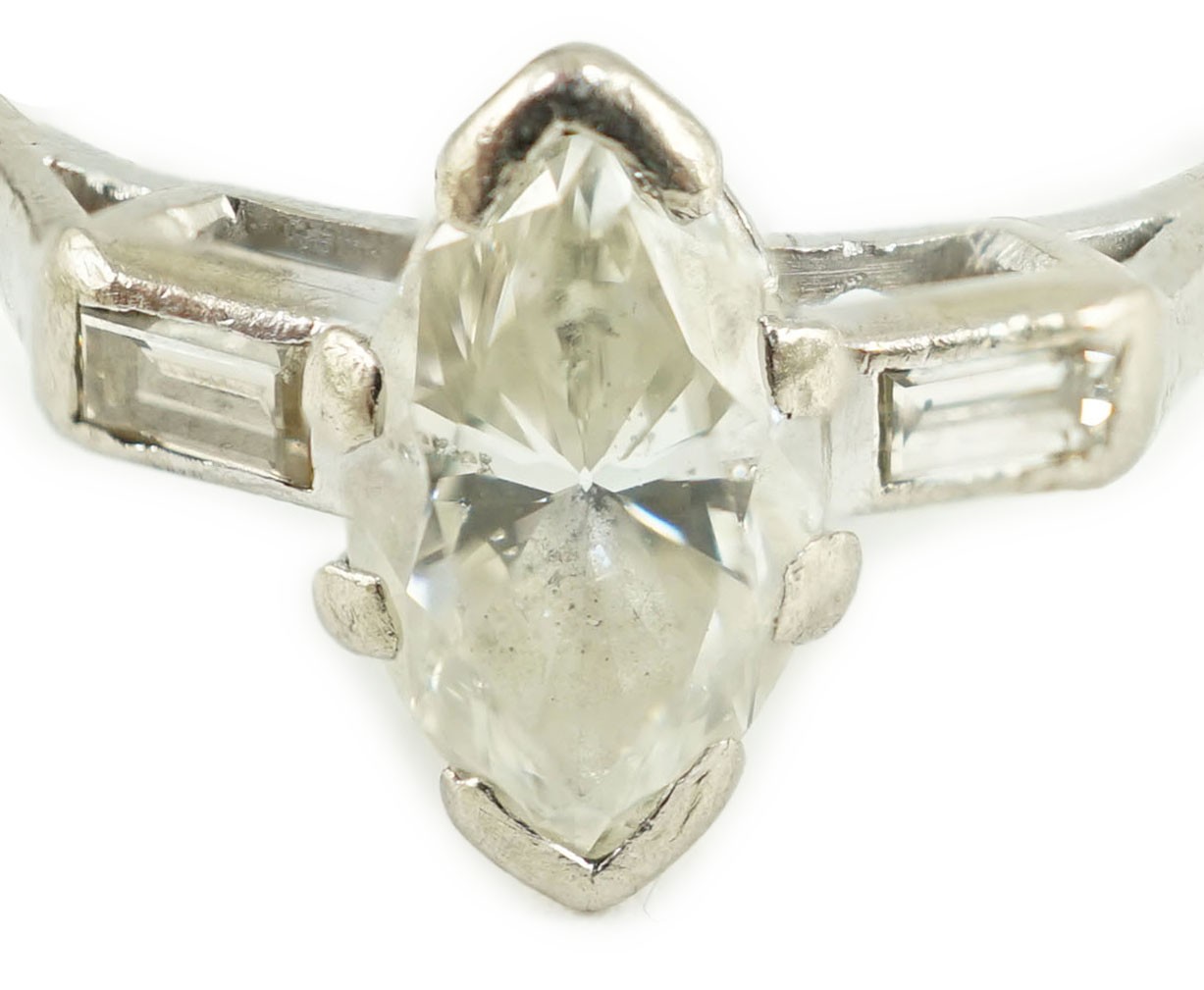 An 18ct white gold and single stone marquise cut diamond set ring, with baguette cut diamond set shoulders